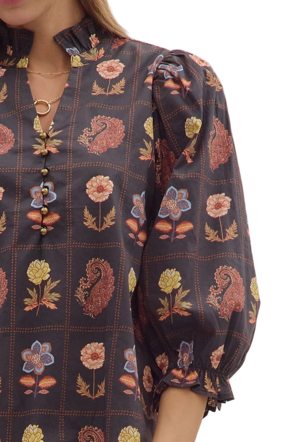 Floral and paisley print 3/4 puff sleeve top featuring ruffled high neck and loop button closure at front. Elasticated sleeve openings with ruffle trim. Unlined. Woven. Non-sheer. Lightweight.
