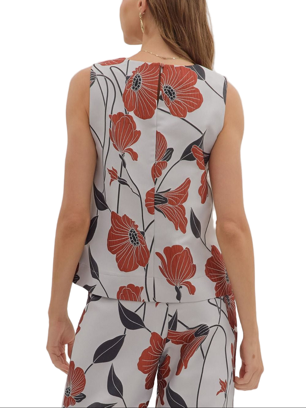 Brighten your wardrobe with the Betsy Pant Set—a fun floral sleeveless top paired perfectly with matching pants. This playful duo offers effortless style and comfort, ideal for sunny days or casual outings where you want to stand out with ease and charm.