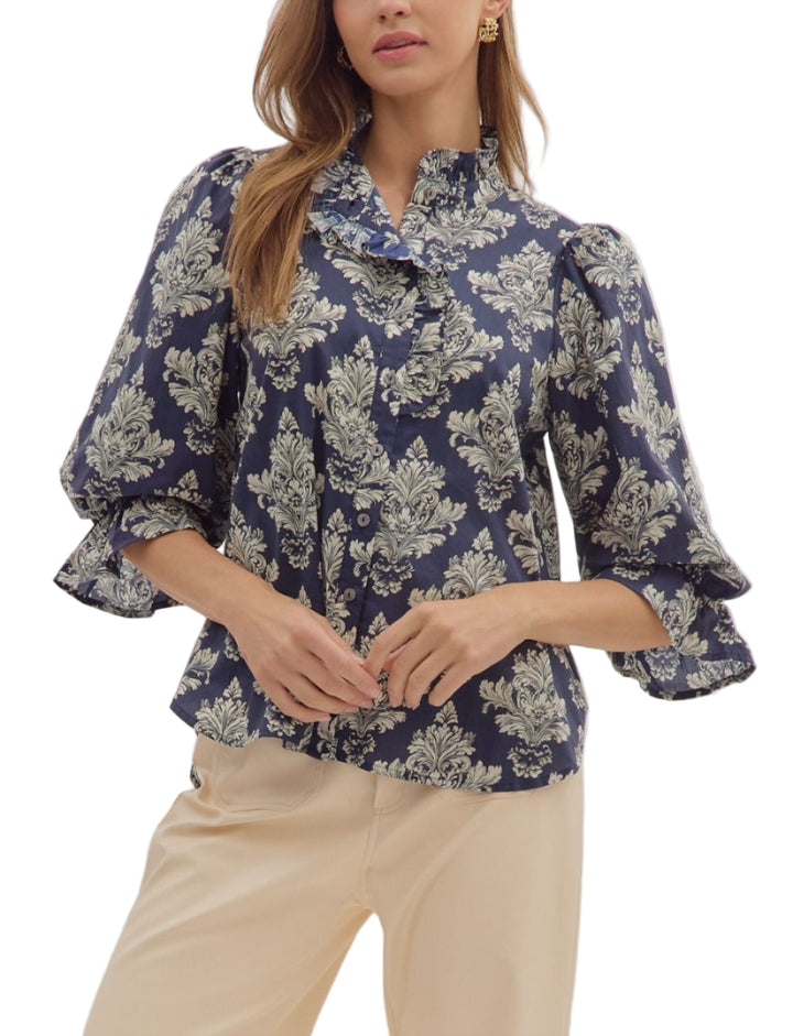 Baroque print 3/4 ruffle cuff puff sleeve top featuring ruffled neck detail. Button closure at front. Unlined. Woven. Non-sheer. Lightweight.
