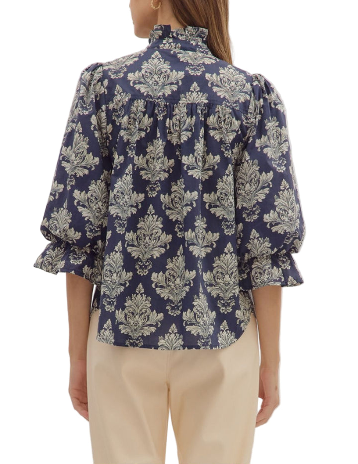 Baroque print 3/4 ruffle cuff puff sleeve top featuring ruffled neck detail. Button closure at front. Unlined. Woven. Non-sheer. Lightweight.
