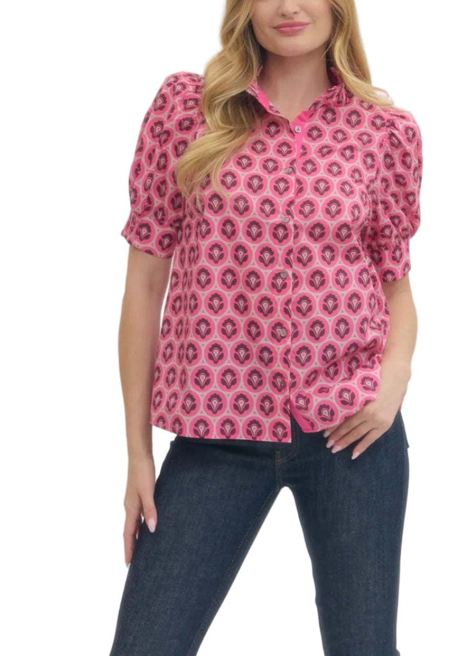 Geometric print short puff sleeve top featuring ruffled mock neck and button closure at front. Smocked cuffs. Unlined. Woven. Non-sheer. Lightweight.
