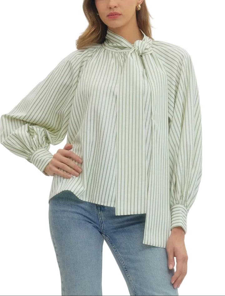 Elevate your everyday style with the Zoey Striped Long Sleeve Blouse, where timeless stripes meet modern charm. This versatile piece features a playful tie neck bow that adds instant personality to any outfit—dress it up for the office or down for weekend adventures. The long sleeves offer coverage and sophistication, while the classic striped pattern keeps things fresh and fun. Perfect for layering or wearing solo, this blouse is your new go-to for effortless style that works as hard as you do.