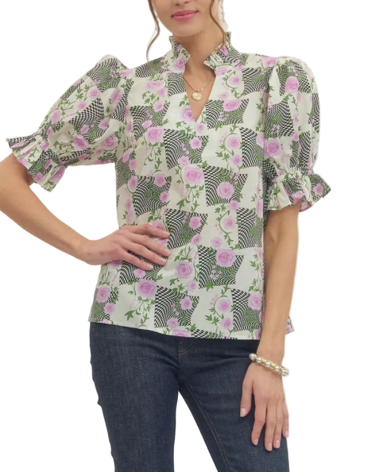 Printed top featuring mixed floral and geometric pattern. Short puff sleeve. Ruffled accent stand collar V-neck. Elasticated sleeve cuffs. Unlined. Woven. Non-sheer. Lightweight.