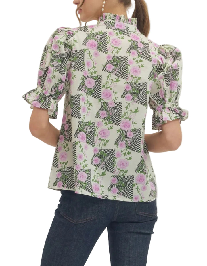 Printed top featuring mixed floral and geometric pattern. Short puff sleeve. Ruffled accent stand collar V-neck. Elasticated sleeve cuffs. Unlined. Woven. Non-sheer. Lightweight.