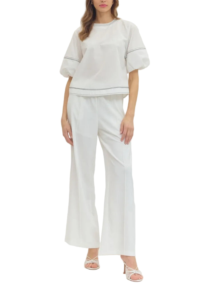 Solid short puff sleeve top featuring contrast stitch detail. Button closure at back. Elasticated sleeve opening. Unlined. Woven. Non-sheer. Lightweight.
