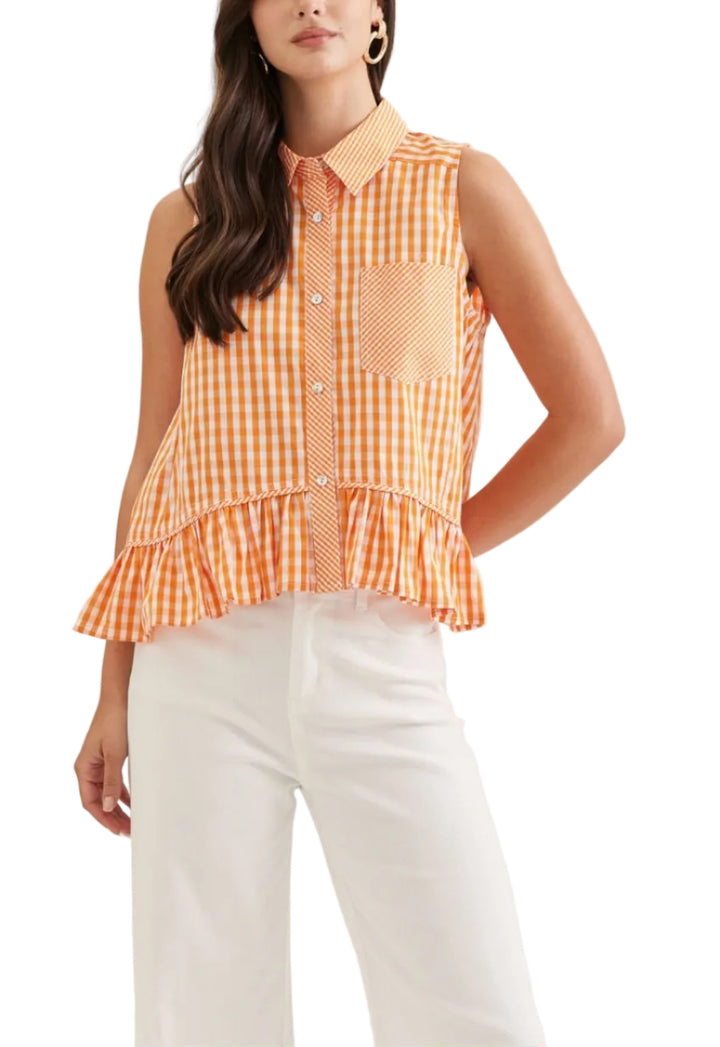 Gingham sleeveless top featuring ruffle hem. Button closure at front. Collar. Front patch pocket. Back patch detail. Unlined. Woven. Non-sheer. Lightweight.