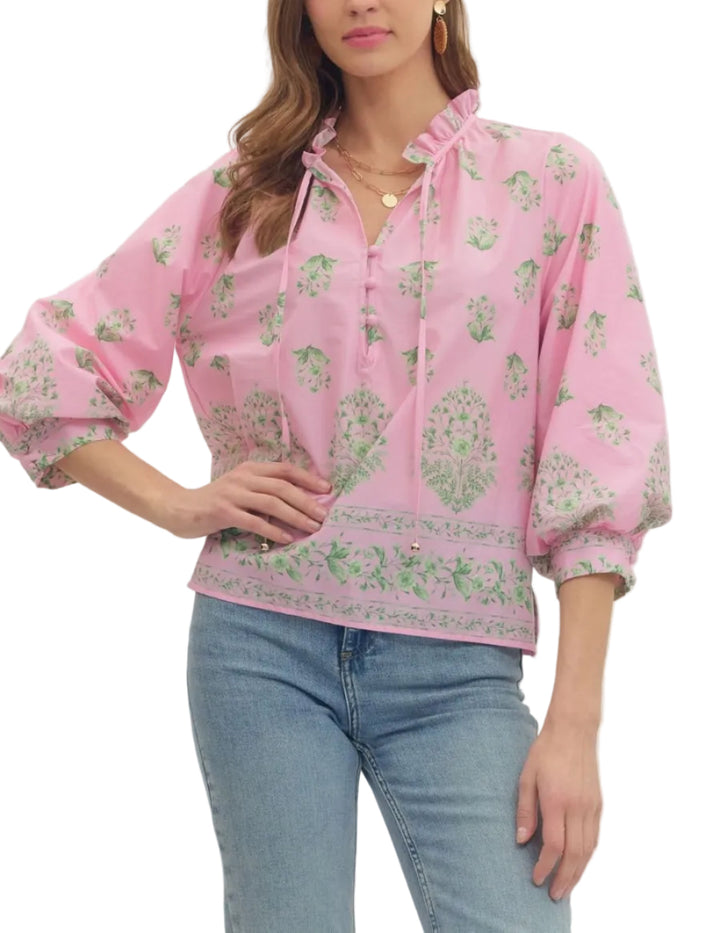Botanical print balloon 3/4 sleeve top featuring ruffle split neckline with button placket. Button closure at cuff. Unlined. Woven. Non-sheer. Lightweight.
