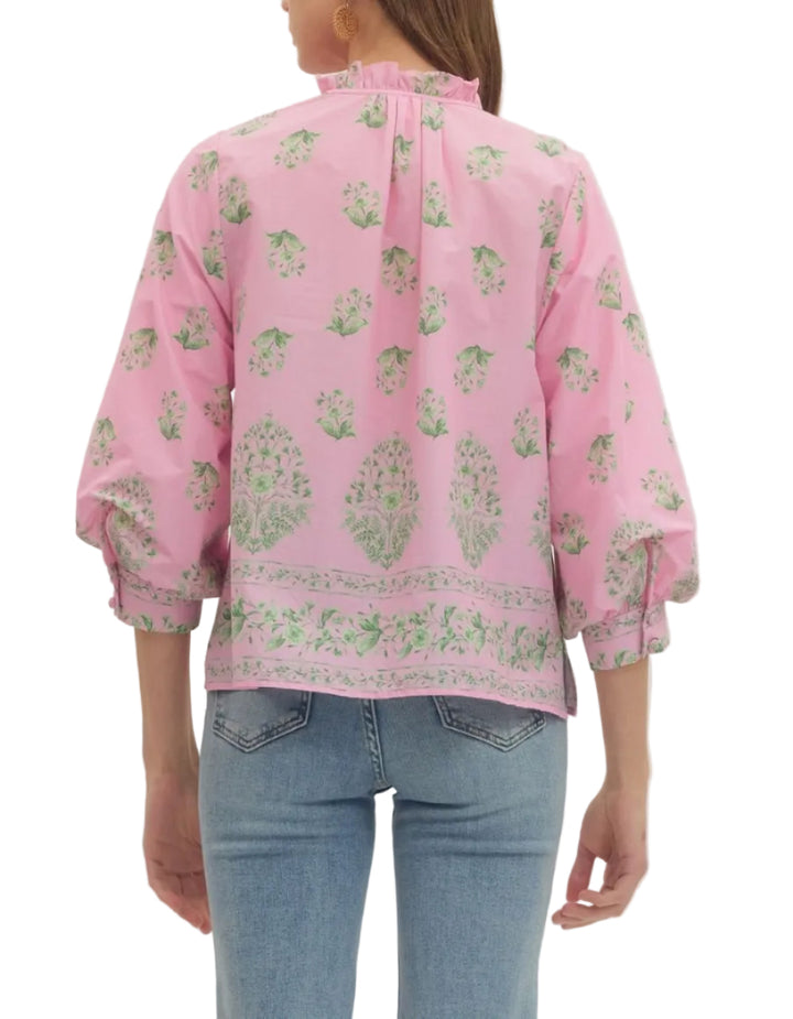 Botanical print balloon 3/4 sleeve top featuring ruffle split neckline with button placket. Button closure at cuff. Unlined. Woven. Non-sheer. Lightweight.
