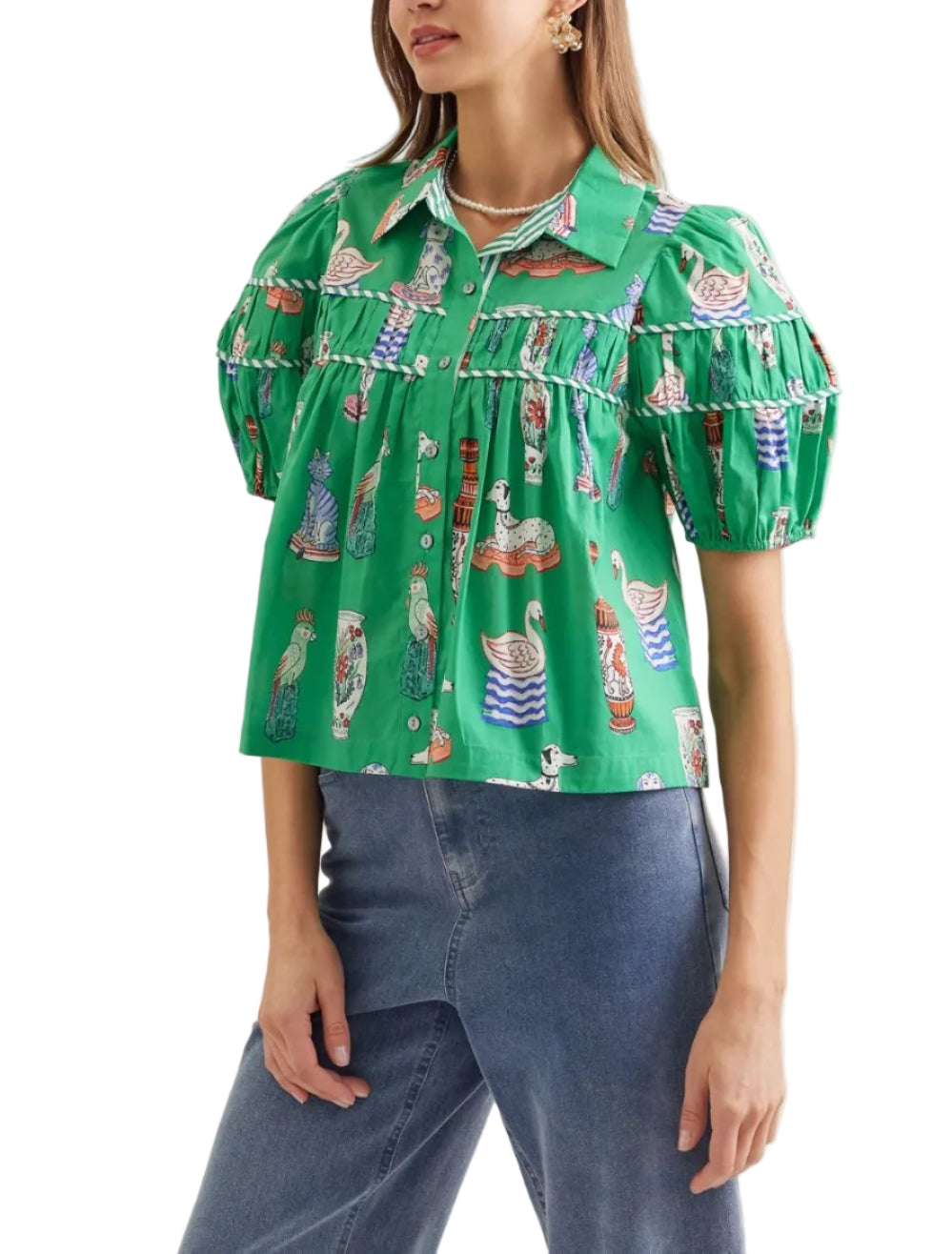 Illustrated novelty print puff sleeve top featuring tiered yoke detail. Button closure at front. Unlined. Woven. Non-sheer. Lightweight.
