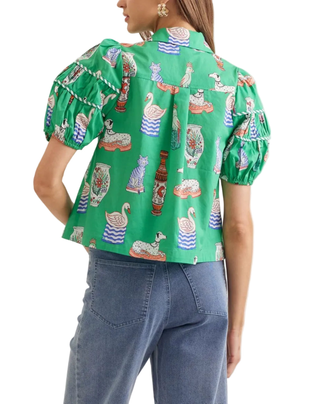 Illustrated novelty print puff sleeve top featuring tiered yoke detail. Button closure at front. Unlined. Woven. Non-sheer. Lightweight.

