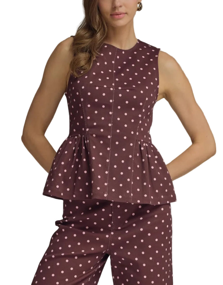 Polka dot sleeveless top featuring peplum hem detail. Back zipper closure. Unlined. Woven. Non-sheer. Lightweight