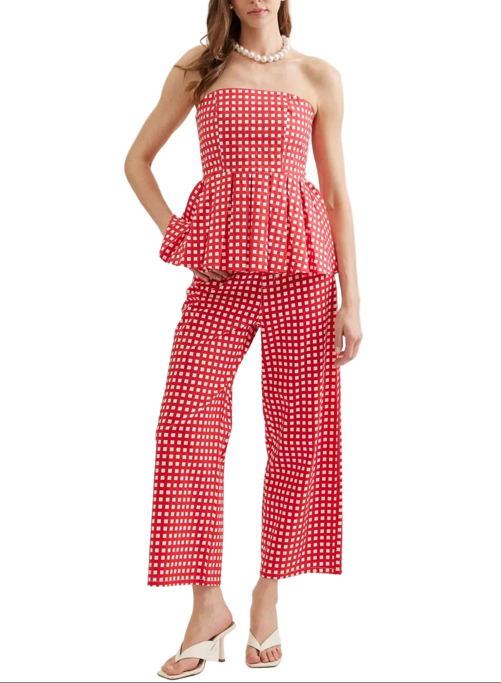 Checkered strapless peplum top featuring flared hem detail. Paired with matching bottoms. Unlined. Woven. Non-sheer. Lightweight. 100% Cotton