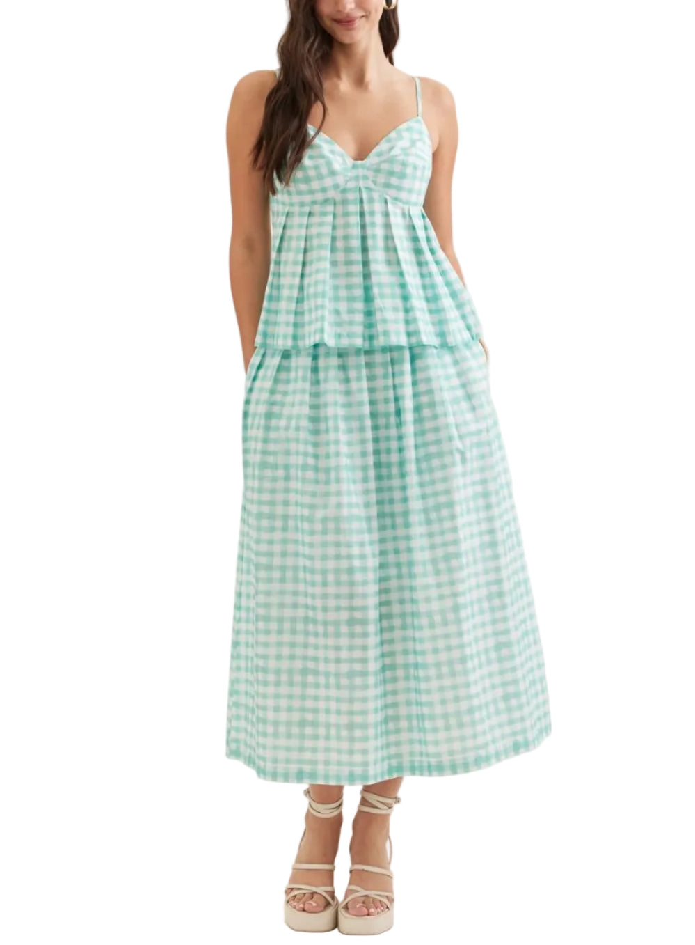 Elevate your wardrobe with the Gracie Gingham Midi Skirt Set. This charming two-piece ensemble features a classic gingham pattern that effortlessly transitions from casual days to evening outings. The midi length offers timeless elegance while the coordinated set design simplifies styling. Perfect for spring and summer occasions, this versatile set pairs beautifully with sneakers for a relaxed look or heels for something more polished.&nbsp;