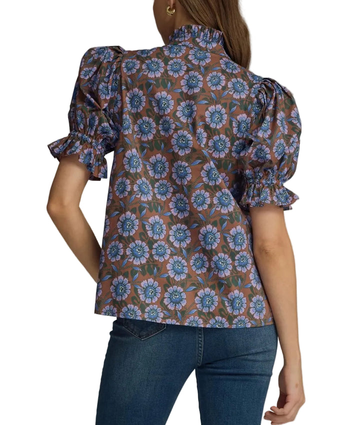 Floral elasticated short puff sleeve top featuring ruffled accent neck band collar V-neck. Elasticated ruffle sleeve hem. Unlined. Woven. Non-sheer. Lightweight.