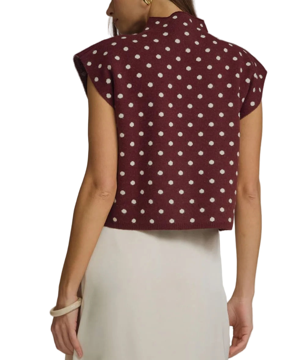 Polka dot mock neck sleeveless top featuring cap sleeve detail. Unlined. Woven. Non-sheer. Lightweight.