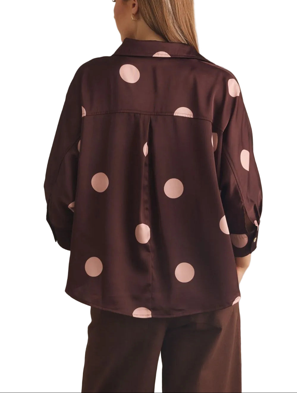 Polka dot collared 3/4 sleeve top featuring button closure at front. Button cuffs. Back pleat detail. Unlined. Woven. Non-sheer. Lightweight.