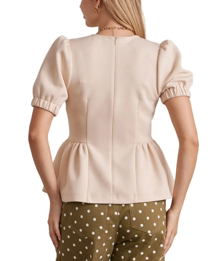 The Brielle Short Sleeve Top features a flattering peplum hem that adds dimension and movement to your everyday wardrobe. Crafted for comfort, this versatile piece pairs effortlessly with jeans, skirts, or trousers. The short sleeves offer breathable wear for warm weather, while the structured peplum detail creates a polished silhouette. Perfect for casual outings or dressed-up occasions.