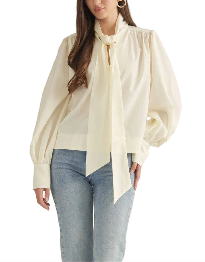 Solid long sleeve top featuring a self-tie detail at neck. Button cuffs. Unlined. Woven. Non-sheer. Lightweight.