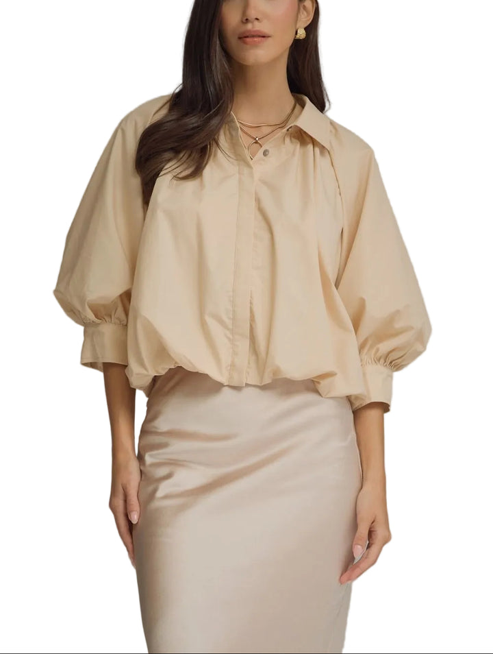 Solid ¾ puff sleeve top featuring gathered detail at front and back yoke. Button closure at front. Button at cuff. Elasticated hem. Lined. Woven. Non-sheer. Lightweight.