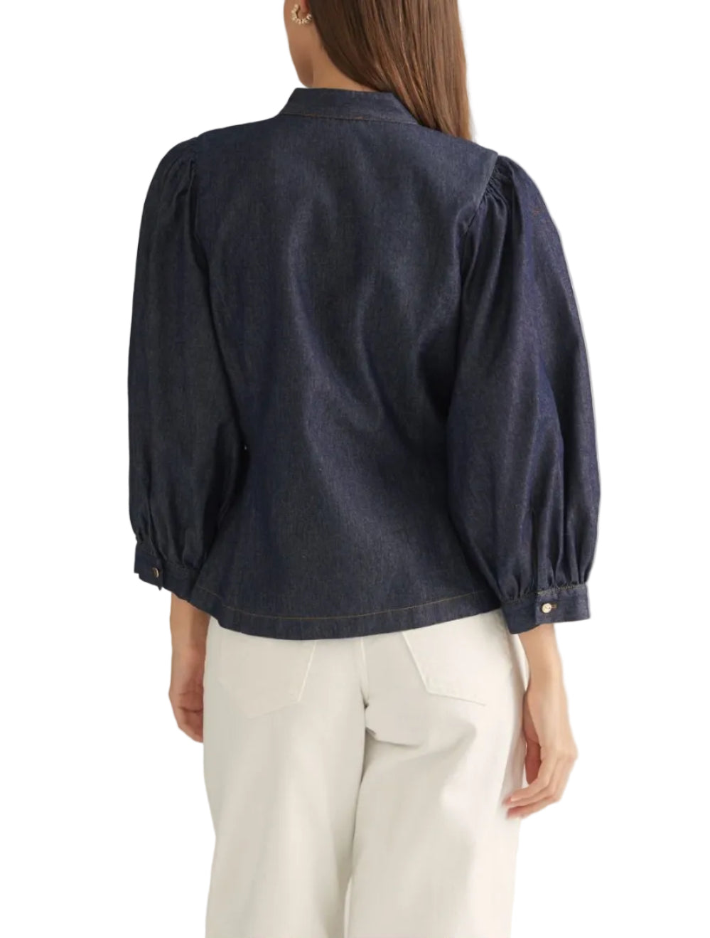 Solid 3/4 puff sleeve denim top with a high neckline and multiple self-tie closures at front. Hidden button closure at front. Button cuffs. Lined. Woven. Non-sheer. Lightweight.
