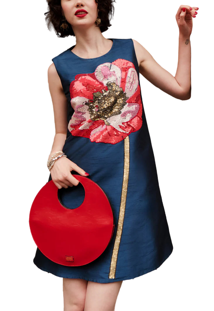 Introducing the silhouette of the season, the Alice Shift Dress. 
Front and center blooms a hand-embroidered Paradise Poppy, rendered in bold sequins and intricate beadwork, designed to catch the light (and every eye in the room). Discreet side pockets and a concealed zipper blend function into form, while the flared shift gives just the right amount of movement.