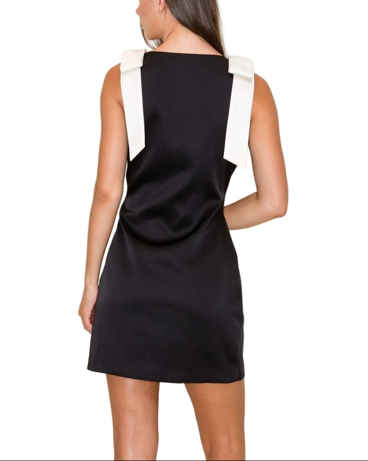Effortless elegance in a sleek black mini. This boat neck sleeveless dress offers a timeless silhouette perfect for casual outings or dressed-up evenings. The minimalist design flatters all body types while the lightweight fabric ensures comfort throughout the day. Pair with sneakers for a relaxed vibe or heels for an instant polish. A versatile wardrobe essential that transitions seamlessly from season to season.