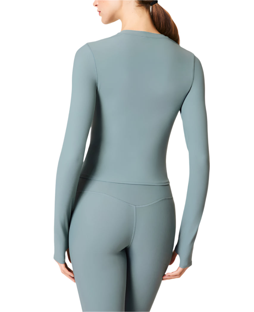 Our SPANXsmooth™ OnForm Long Sleeve Top is made from buttery-soft, lightweight performance fabric with gentle smoothing built in. Breathable, sweat-wicking, and crafted with 4-way stretch, this long sleeve shirt features convenient thumbholes for a secure fit (and added warmth). This versatile activewear style moves with you, and is perfect for before, during, and after your low-intensity workouts like pilates or yoga.