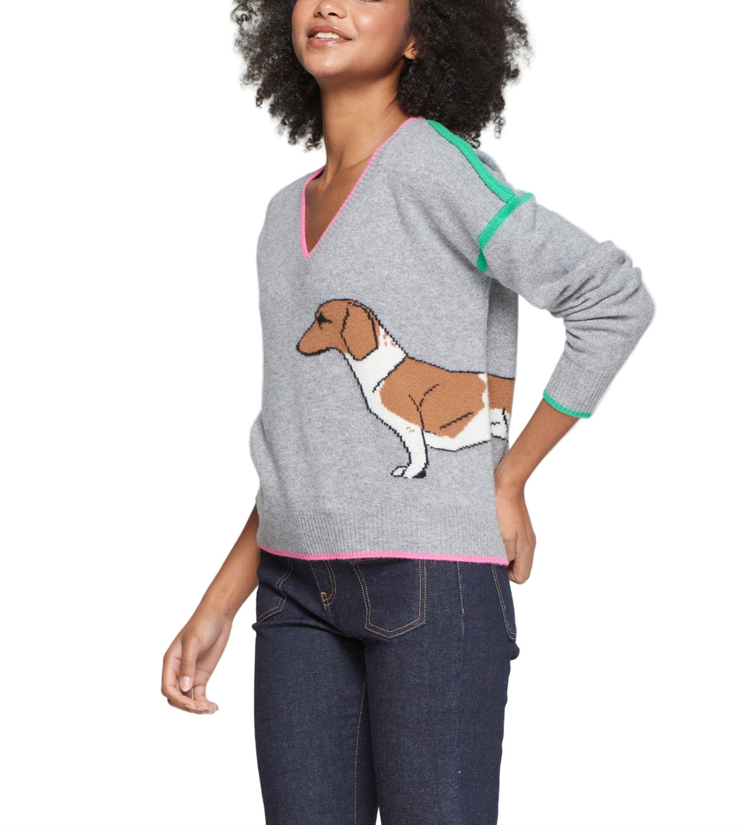 Grey wool knit sweater featuring an intarsia dachshund design on both sides. V-neckline trimmed in pink, with green accent stripes on shoulders and cuffs. Made from 100% wool with a soft touch and light structure. Straight cut with pink hem and natural drape.