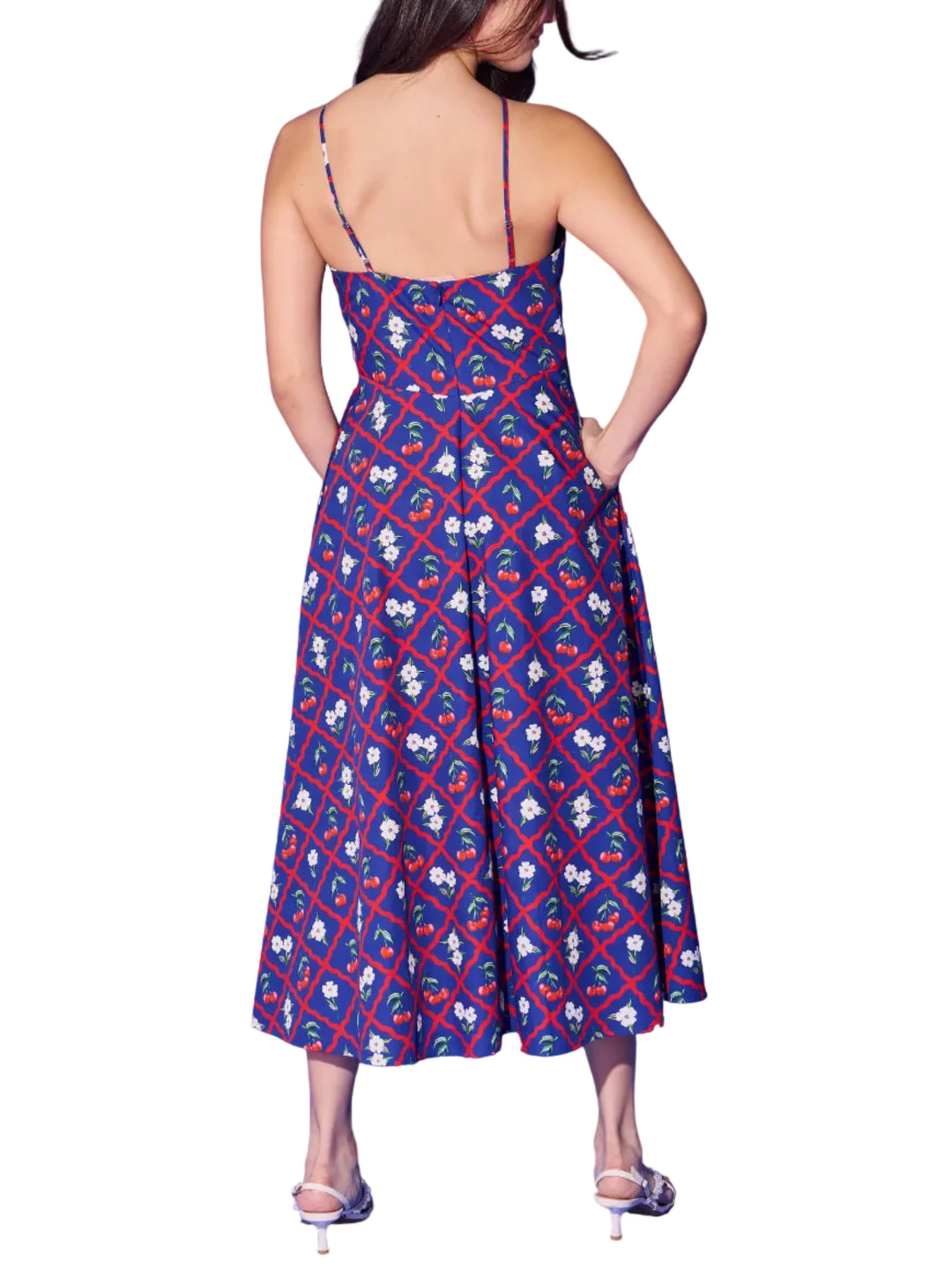 The Karin Dress is the navy cherry lattice print at its most elegant. A sleek halter neckline with delicate cross-back straps frames the shoulders beautifully, while the fitted bodice flows into a full, sweeping midi skirt that moves with effortless grace. Bold red trellis, bright cherries, and white florals pop against the deep navy ground for a look that&