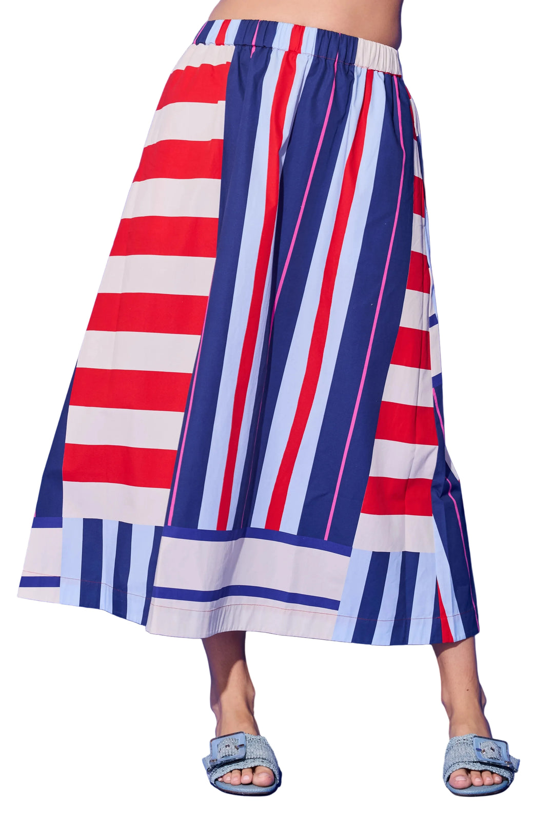 Red, white, and blue striped skirt on a person against a blue background