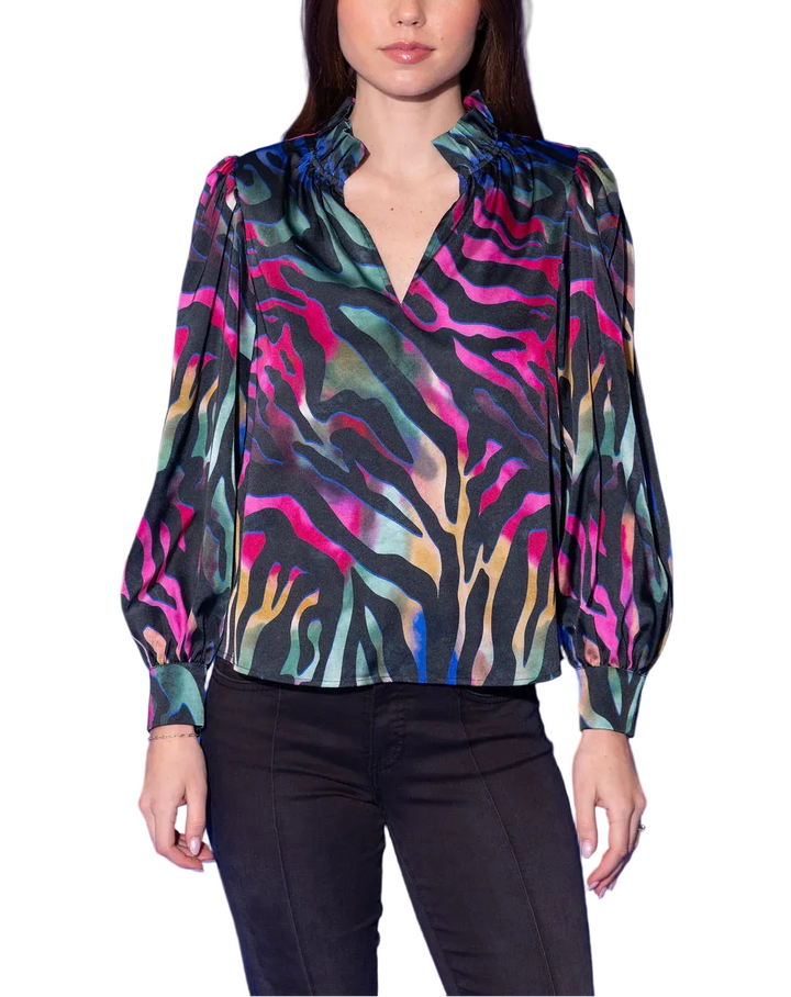 The Phoebe Top in Prism Zebra is wild, vibrant, and completely electric. A bold zebra-stripe pattern comes alive in a neon wash of hot pink, teal, gold, and sage against a dramatic black ground — fierce, colorful, and utterly unforgettable. A ruffled split neckline and voluminous long sleeves with elasticized cuffs add a beautifully feminine finish to this head-turning statement top.