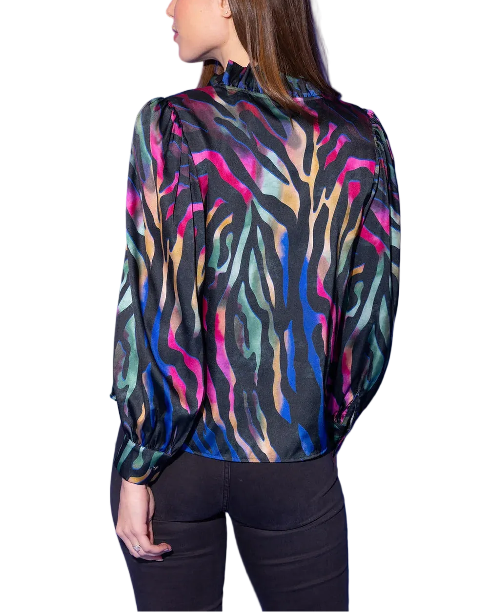 The Phoebe Top in Prism Zebra is wild, vibrant, and completely electric. A bold zebra-stripe pattern comes alive in a neon wash of hot pink, teal, gold, and sage against a dramatic black ground — fierce, colorful, and utterly unforgettable. A ruffled split neckline and voluminous long sleeves with elasticized cuffs add a beautifully feminine finish to this head-turning statement top.