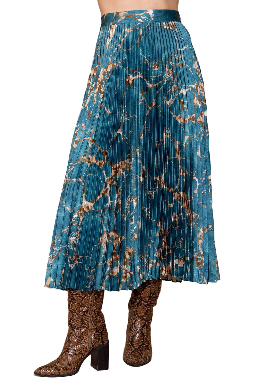 A pleated midi skirt in a teal blue and brown marble print, styled with brown snakeskin-embossed ankle boots against a solid beige background.