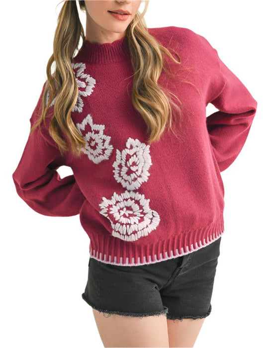 Soft sweater knit shapes this essential sweater top that has a scalloped mock neckline framed by drop shoulder long sleeves. Floral embroidery decorates the front and contrasting ribbed knit accents the cuffs and hem.