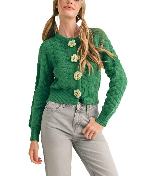 textured sweater knit that shapes a button front design with knit rosettes and a relaxed fit framed by long sleeves with ribbed cuffs.