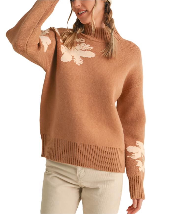 Warm sweater knit shapes this pullover that has cute floral knit detail on the shoulders and sleeves, a mock neckline, long sleeves, and a relaxed bodice.