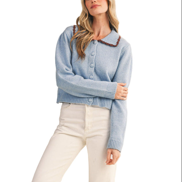 Set yourself up for a posh & cozy day in this scalloped collar sweater cardigan! Cozy knit shapes this must-have cardigan that has a ribbed collar neckline accented with scalloped edges in a contrast knit color. Gathered puff shoulders flow into long sleeves with ribbed cuffs. Covered, functional buttons adorn the front of the relaxed bodice