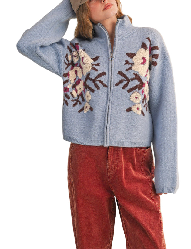 Your outfits will always be casually cute when you've got this zip-up sweater cardigan! Soft and cozy knit shapes long puff sleeves that frame a bodice with a ribbed stand collar, a zip-up closure, and semi-cropped relaxed bodice. Stunning floral knit design gives this cardigan the extra "oomph" your closet needs!