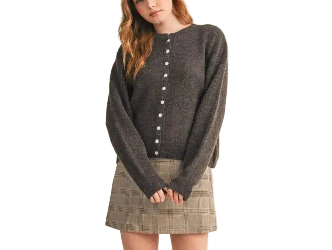Elevate your everyday wardrobe with the Eliana Cardigan Sweater. This versatile layering piece features a classic button-front design and comfortable fit, perfect for transitioning between seasons. Crafted for both style and ease, it pairs effortlessly with jeans, dresses, or trousers. A timeless essential that works as hard as you do.
