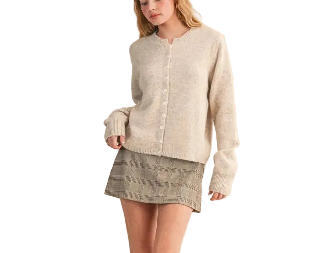 Elevate your everyday wardrobe with the Eliana Cardigan Sweater. This versatile layering piece features a classic button-front design and comfortable fit, perfect for transitioning between seasons. Crafted for both style and ease, it pairs effortlessly with jeans, dresses, or trousers. A timeless essential that works as hard as you do.