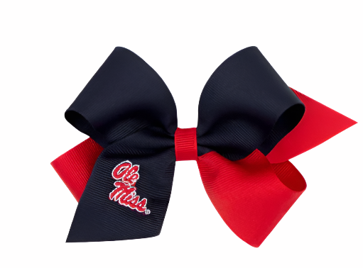 A two-tone embroidered grosgrain hair bow with one side in dark navy and the other in red, featuring white text &