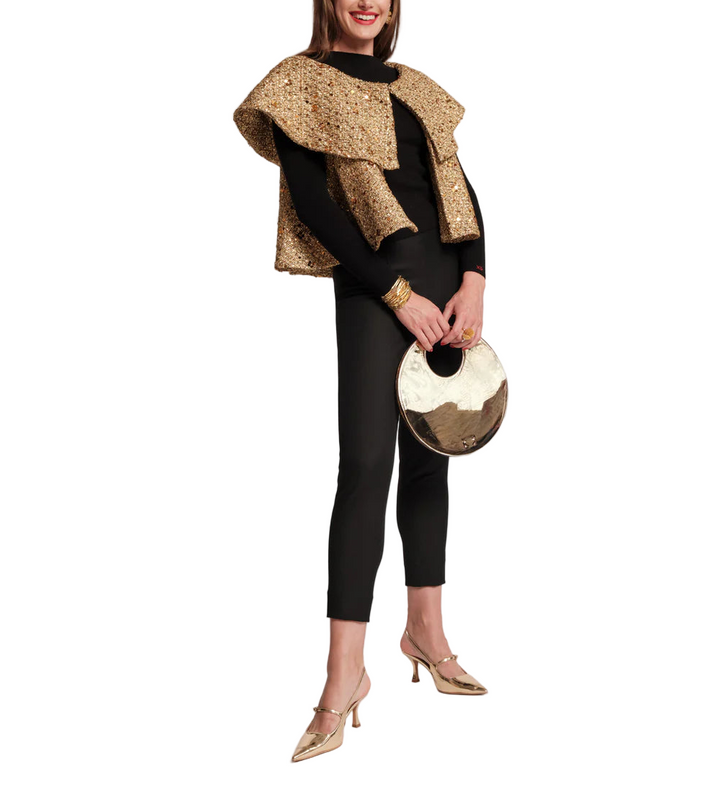 Elevate your holiday look with the Peyton Swing Jacket, a luxurious topper designed to drape effortlessly over your favorite look. Crafted with a shimmering metallic tweed and swaying silhouette, it features cape styling, with open arm holes for ease of movement. The double-layer collar and a captivating mix of wool and sequins adds a touch of subtle glamour. Top off your go-to festive outfit to add a touch of warmth and sparkle to any special night.