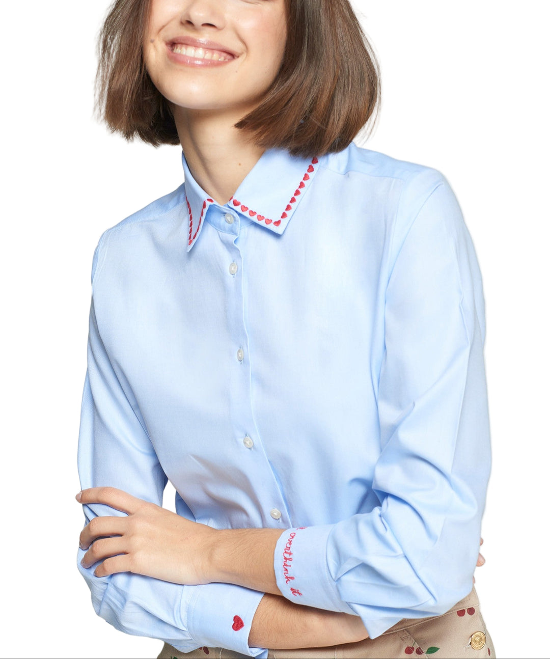 Classic-fit light blue shirt with a pointed collar embroidered with a line of red hearts. Red “Don’t overthink it” text embroidered on the cuff and a “Made with love” message on the back of the collar in black thread. Front closure with visible buttons. Curved hem. Structured yet light poplin fabric.