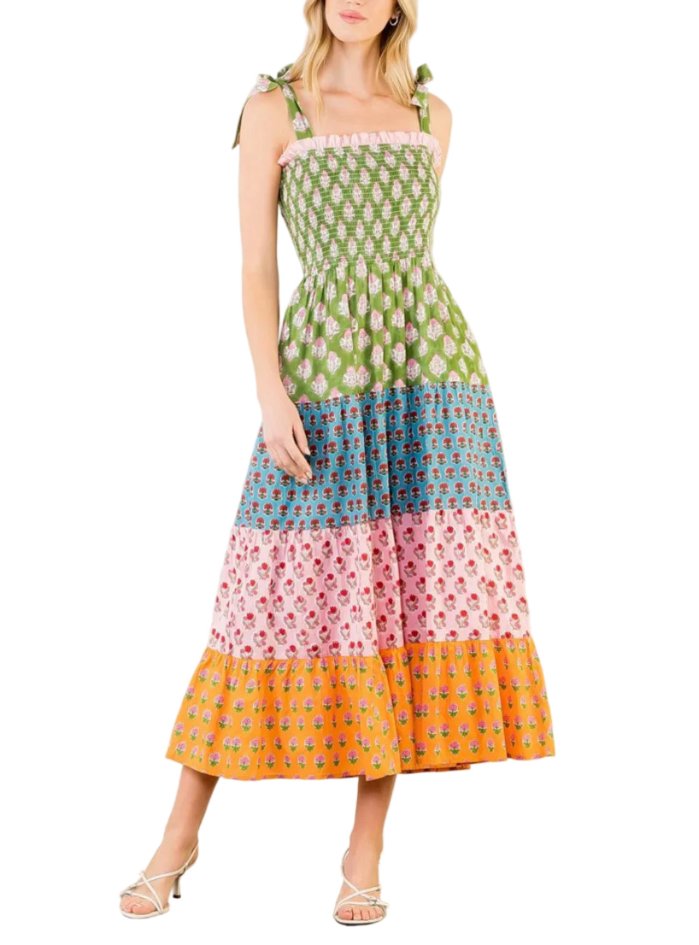 Woman wearing a colorful patterned dress on a white background