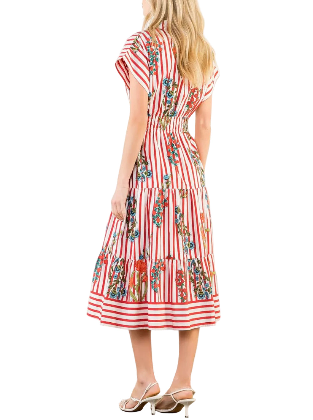 Woman wearing a red and white striped dress with floral patterns on a white background