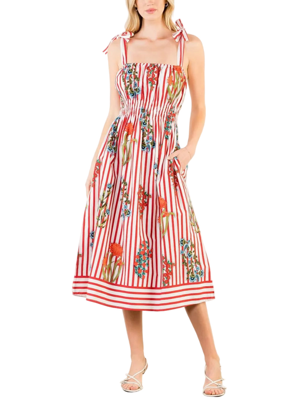 Woman wearing a red and white striped dress with floral patterns on a white background