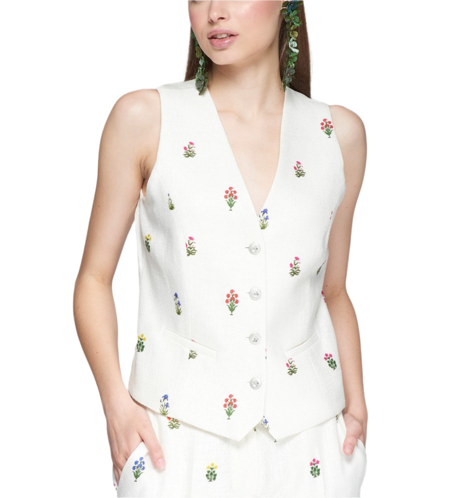 Fitted waistcoat in white linen with embroidered flowers. Front fastening with metal buttons. Front pockets. Matching trousers and jacket available.